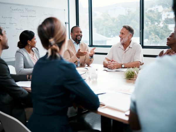 Shot of a group of businesspeople listening to a colleagues ideas during a meeting.